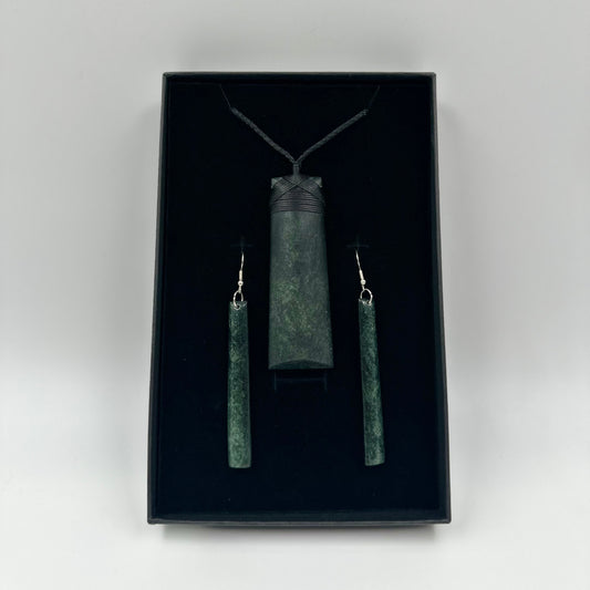 Jewelry set with pendant and earrings in a black box on a white 
background